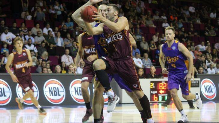Brisbane guard Adam Gibson glides to the basket past Sydney Kings centre Aleks Maric on Saturday night. Photo: Joshua Paterson