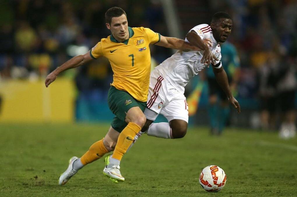 Possession is king: Mathew Leckie and Ismail Al Hammadi fight for possession on Tuesday night.