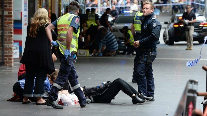 Police and paramedics with an injured pedestrian Photo: Justin McManus