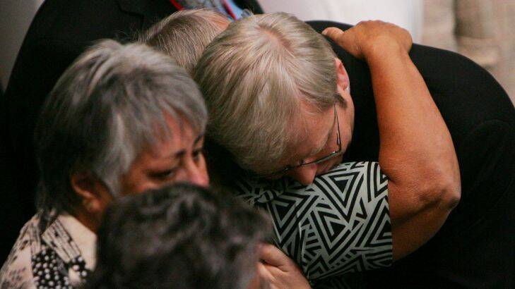 Prime Minister Kevin Rudd hugs indigenous guests after his apology to indigenous Australian at Parliament House, canberra, Wednesday, Feb. 13, 2008. Rudd's apology referred to the "past mistreatment" of all Aborigines, singling out the "Stolen Generations", the tens of thousands of Aboriginal children taken from their families by governments between 1910 and the early 1970s, in a bid to assimilate them into white society. (AAP Image/News Ltd Pool/Gary Ramage)