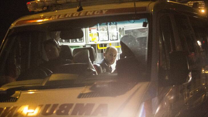 Ambulance officers tend to the injured policeman at Preston on Thursday night. Photo: Craig Sillitoe