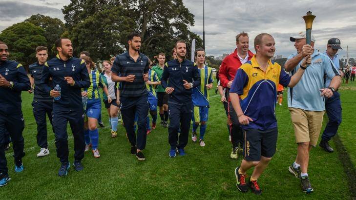 Meeting the stars: Andros Townsend (carrying water bottle) and other Tottenham Hotspur players conducted a coaching clinic at Birchgrove Oval with players from the Special Olympics football team. Photo: Brendan Esposito