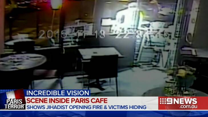 The gunman - seen as a white figure - outside the pizzeria in a screengrab from the CCTV footage. Photo: Supplied