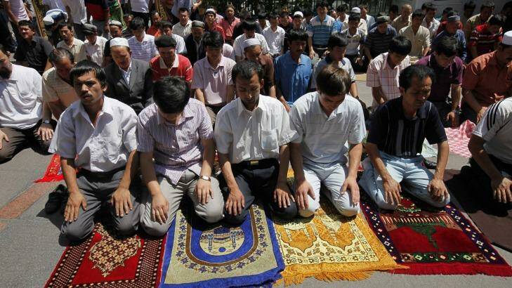 Uighur men pray in a mosque in Urumqi, western China's Xinjiang province.  Photo: AP/File