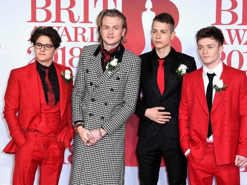 The Vamps wearing white roses at the Brit Awards in support of the Me Too movement.