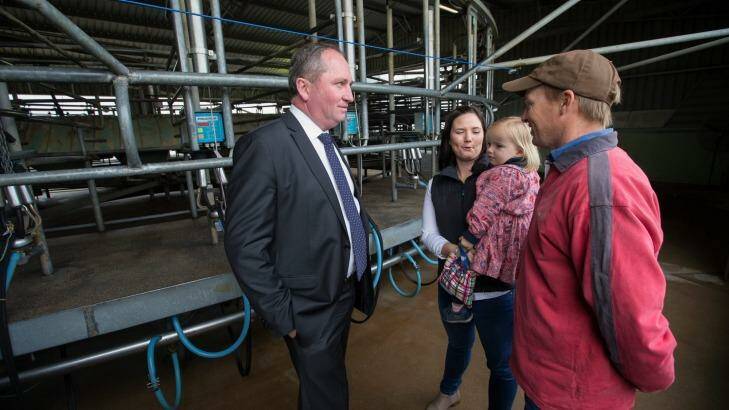 Deputy Prime Minister and Nationals Leader Barnaby Joyce meets with dairy farmer Ashley and Lucy Galt, with 3 year old Alice last week. Photo: Jason South