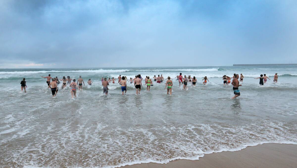 Dozens of people braved the icy waters of Lady Bay for the annual surf club winter solstice swim.  Picture: ROB GUNSTONE