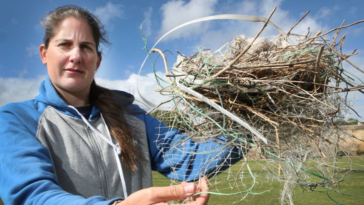 Volunteer wildlife carer Shannon McKay holds the nest, made largely from rubbish. Picture: LEANNE PICKETT