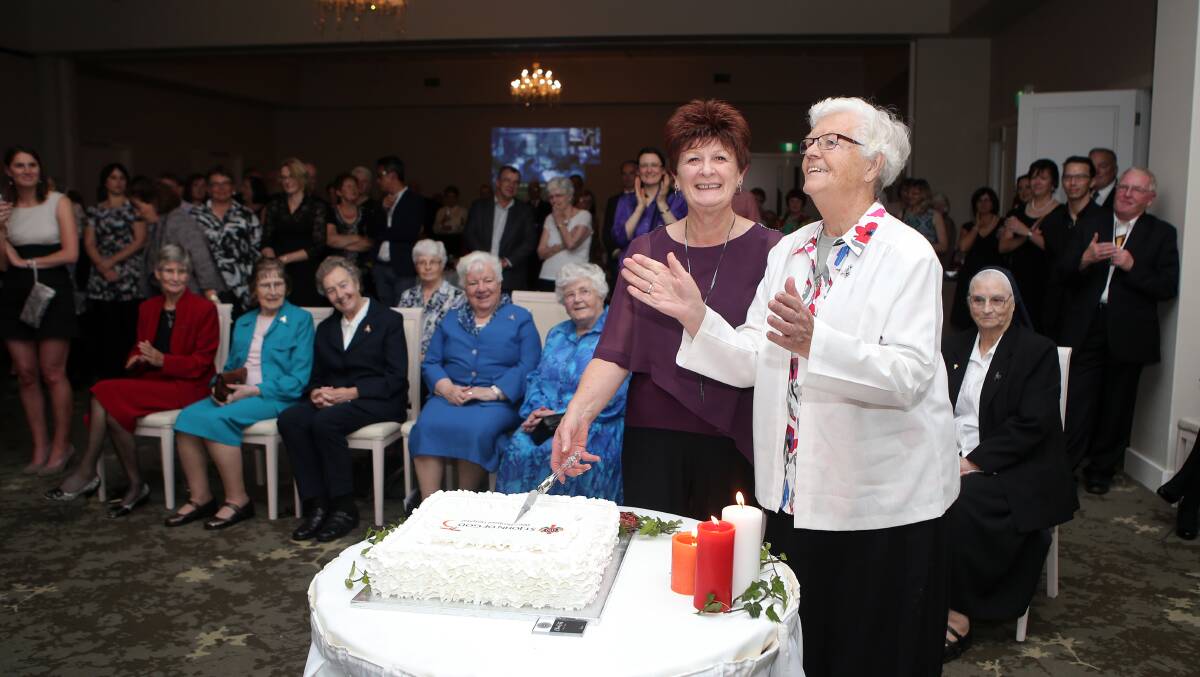 Long-serving hospital worker Rosemary Moore (left) and Sister Dominica O’Reilly cutting the cake at the 75th anniversary celebrations.