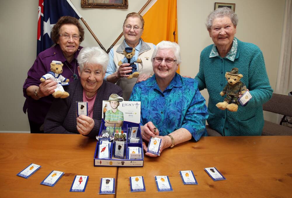Legacy members (from left) Gwen Cross, Olive Francis, Anna Hollingsworth, Heather Morris and Lois Blain with the range of badges and teddies for sale. Picture: DAMIAN WHITE