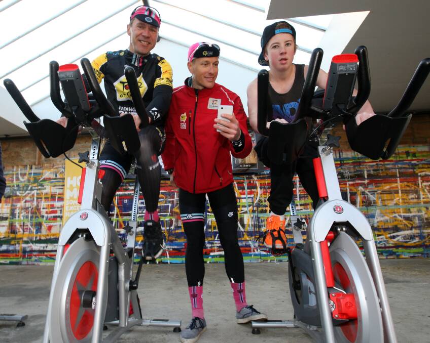 German cyclist Jens Voigt (left), Sydney cyclist Ben Turner and Zac Cashill, of Warrnambool, warm up on exercise bikes. Picture: LEANNE PICKETT