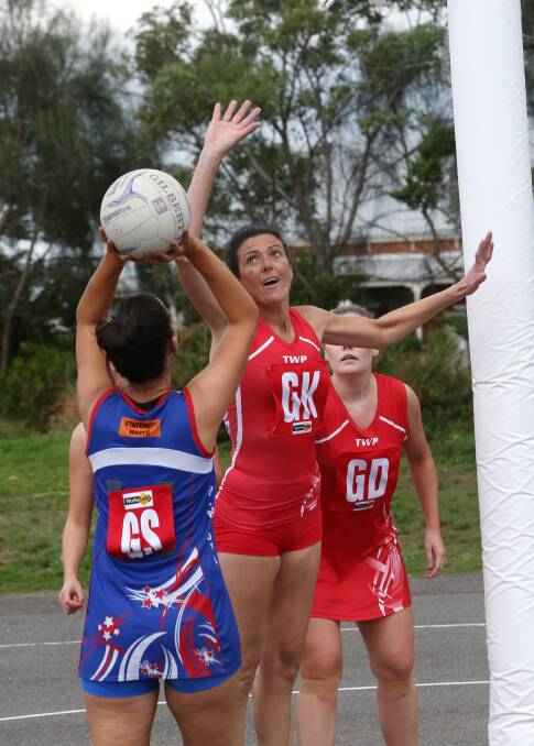 Panmure goal shooter Charlotte McCutcheon prepares to fire over her Dennington opponent Lana Keane in a contest the Dogs controlled after quarter-time.   Picture: AARON SAWALL