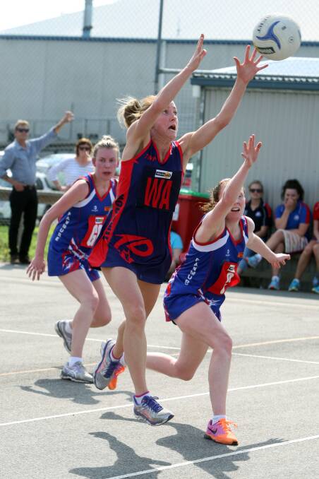 Timboon Demons wing attack Melissa McKenzie (centre) edges out her Panmure opponents Sally O’Keefe (left) and Natalie Kenna in their WDFNL A grade clash. 