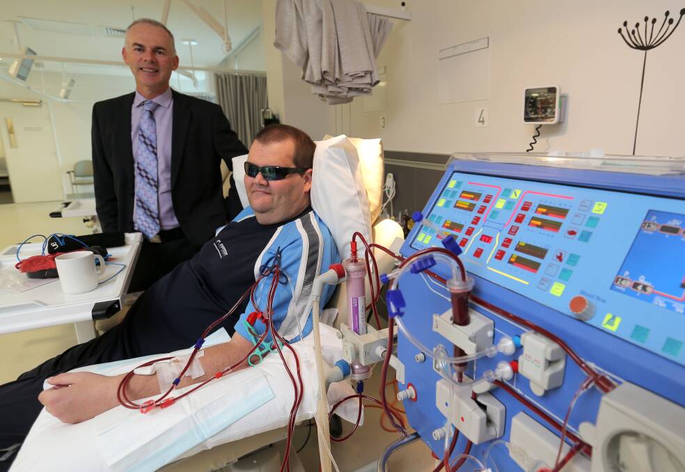 South West Healthcare CEO John Krygger oversees Warrnambool’s Craig Gent as he undergoes kidney dialysis at Warrnambool Base Hospital, meaning he no longer has to travel to Portland three times a week for treatment. Picture: ROB GUNSTONE