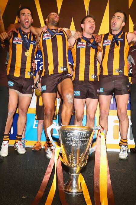 ABOVE: Jordan Lewis (left), Josh Gibson, Liam Shiels and Brian Lake sing the Hawthorn theme song after their stunning win over the Swans on Saturday.