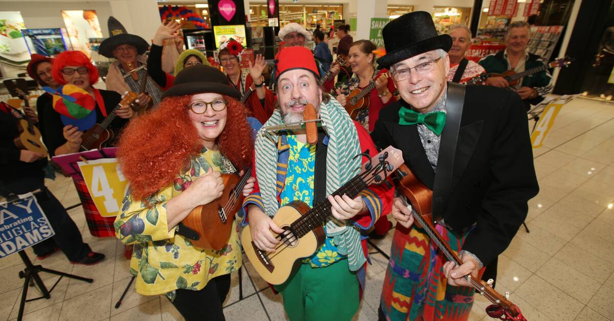 Warrnambool Ukulele Group’s Annie Carmichael (left), Victor Reid and Kevin O’Toole pay homage to author Douglas Adams (Hitchhikers Guide To The Galaxy) and mark Towel Day with a zany and fun performance at Gateway Plaza yesterday.