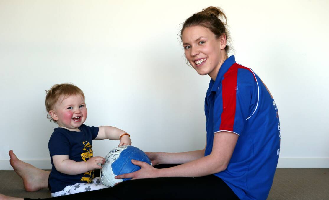Panmure defender Sally O’Keefe has a ball with her 13-month-old son Hendrex before confronting the serious sporting challenge of winning a preliminary final with her Bulldogs teammates. 