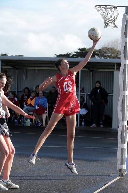 Dennington goal shooter Lana Keane is in clear air to gather the ball under the post in the Dogs’ win over Allansford.