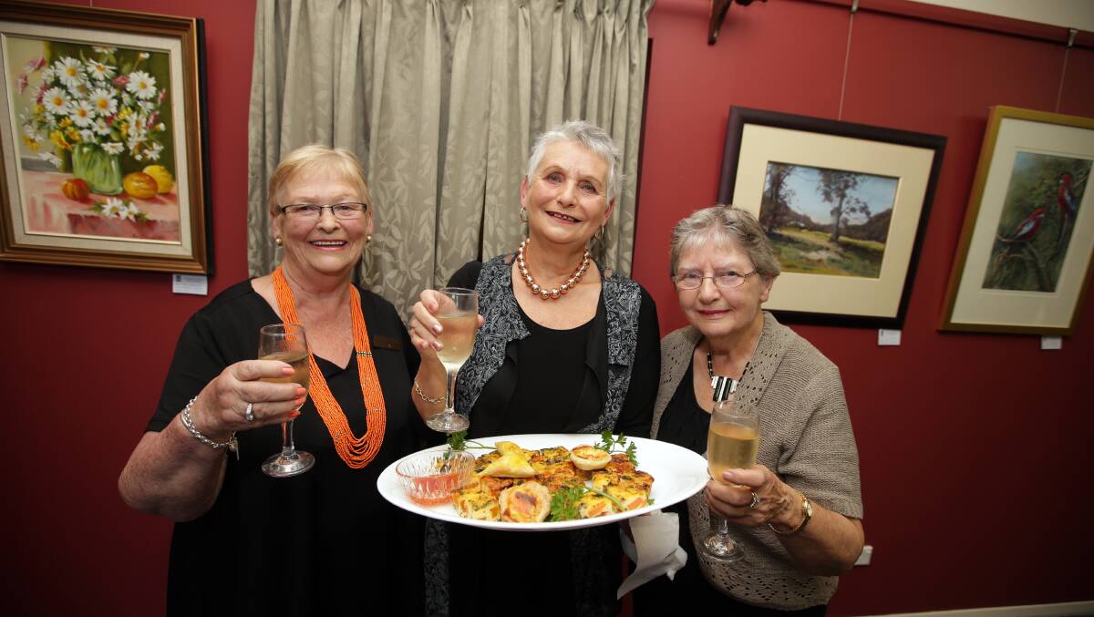 President of Warrnambool and District Artist Society Maureen Healey, left, with committee members Wilma Williams and Gwen Grayson enjoying the knife, fork and brush dinner.