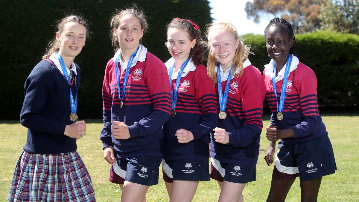 Successful Emmanuel College students Laura Lafferty (left), who won the under 16 800m title, and girls’ under 12-13 4x100m relay winners Molly McKinnon, 13, Natalie Farley, 13, Ebony Marris, 12 and Junia Lual, 13. 