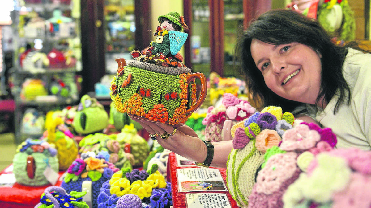 FEELING COSY:  Kylie Richards of Campbell’s Store with some of the tea cosies on display.   	Picture by STUART SCOTT 
