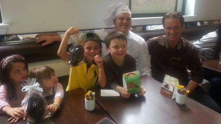 Children (from left) Paige Rowney, Kate Hinchcliff, Henry Hinchcliff and Zachary Rowney with a Lindt chef and manager Tori Johnson. Photo: Supplied