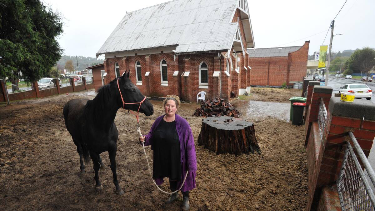 FURORE: Kathy Pope with her horse Missy Moo in her deconsecrated Selwyn Street church yard.
