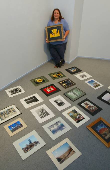 Warrnambool Camera Club president Karen O'Brien with exhibits from the group's exhibition. 