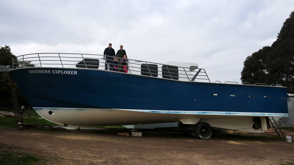 Will Pender and Barry Pender, with Will's daughters Amelia, 2, and Ruby, 4, on the deck of the 60 foot aluminium mono-hull boat, "Southern Explorer" that Barry designed, and they both built. 140819RG15 Picture: ROB GUNSTONE