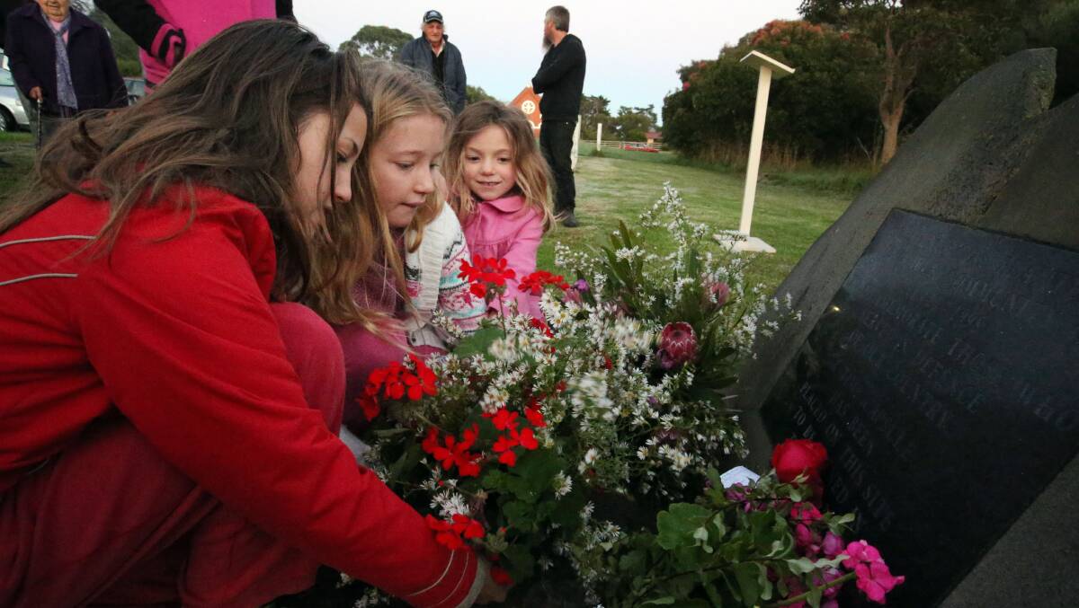 Sisters Lili , Molly and Poppi Hocking fromYambuk lay a wreath. Picture: LEANNE PICKETT