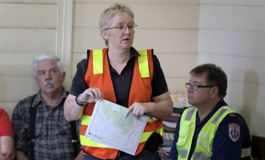 Glenelg Shire Municipal Recovery Manager, Sam Sharp, talks to residents gathered at the Narrawong Mechanics Hall, to brief them on the fire burning in the Mt Clay State Forest. Pictures: ROB GUNSTONE