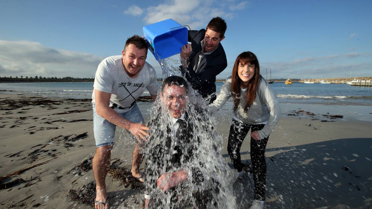 Warrnambool mayor Mike Neoh yesterday took one for the Coast FM breakfast team of Matty Stewart (left), Matthew Monk and Lauren Temuskos to promote Sunday’s attempt at the World’s Biggest Ice Bucket Challenge for motor neurone disease. 140826DW61 Picture: DAMIAN WHITE 