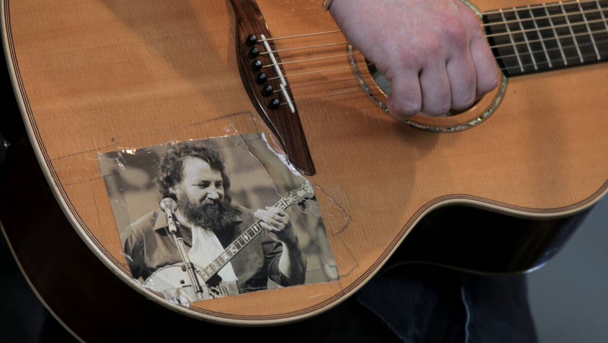 A photo of Barney McKenna from The Dubliners taped to Damian Dempsey's guitar. 
