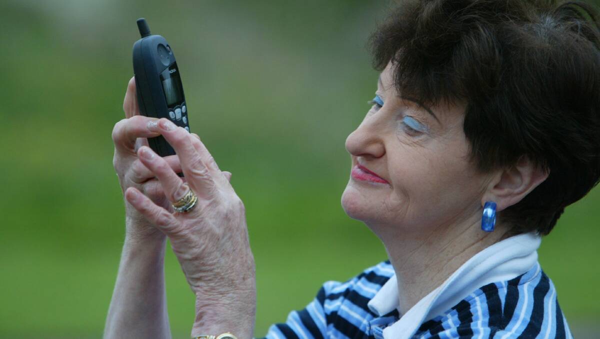 Grandmother Joan Ryan shows off her new mobile phone skills learnt during a course at SEAL. 
