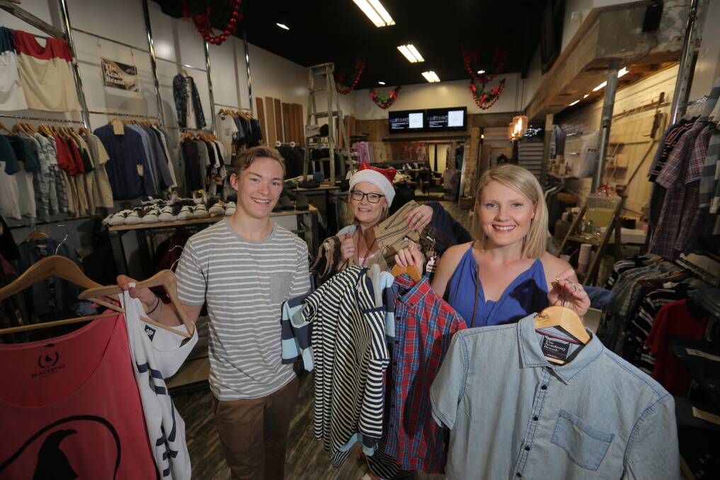 Pitstop fashion consultants Adam Hancock, Bec Kelly and Alex Bright prepare the store for today’s shopping onslaught. 141223VH12 Picture: VICKY HUGHSON