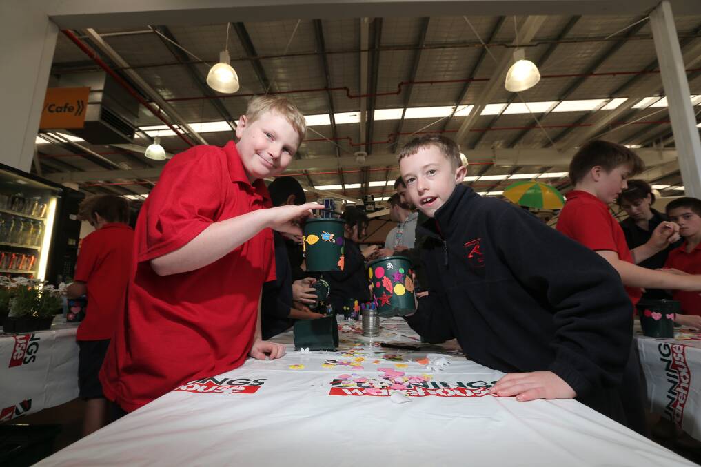 Izac Primmer, 11, and Braeden Pogson, 11, making Mother’s Day gifts at Bunnings Warehouse. 150422AS40 Picture: AARON SAWALL