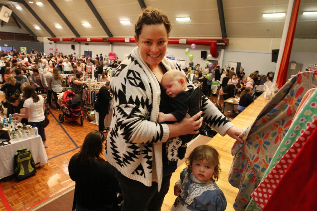 Christine Brunt with nine-month-old Howie Brunt and two-year-old Mill Mill Brunt look at clothes from Baby Bird Boutique at the Baby and Child Bonanza. 141019LP06 Picture: LEANNE PICKETT