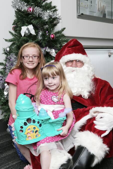 Young patients Allana, 12, and Elizabeth Cannon, 3, from Warrnambool, delayed their hospital departure to welcome Santa. 