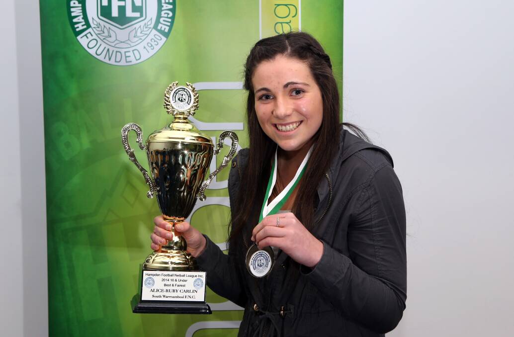 South Warrnambool’s Alice Carlin, 16, with the spoils of her best and fairest success.140819DW38 Picture: DAMIAN WHITE