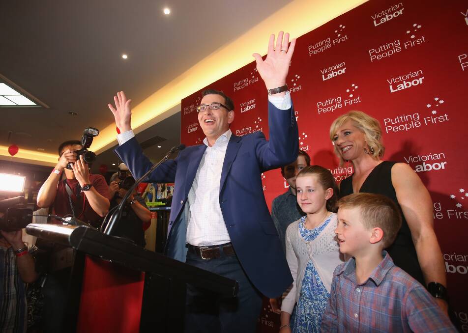 Victorian Labor party leader and Premier-elect Daniel Andrews celebrates his win with wife Catherine and his family on stage at Mulgrave Country Club. Picture: FAIRFAX