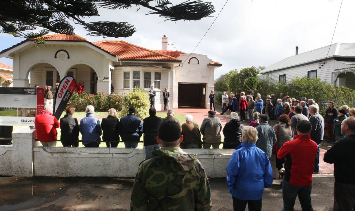 Auctioneer Matt Northeast fronts the crowd at 86 Gipps Street, Port Fairy, on Saturday. 