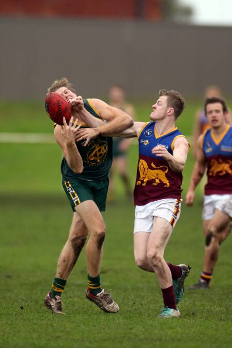 Old Collegians’ Daniel Weel withstands some in-your-face pressure from South Rovers opponent Jess McCosker in a marking contest. 