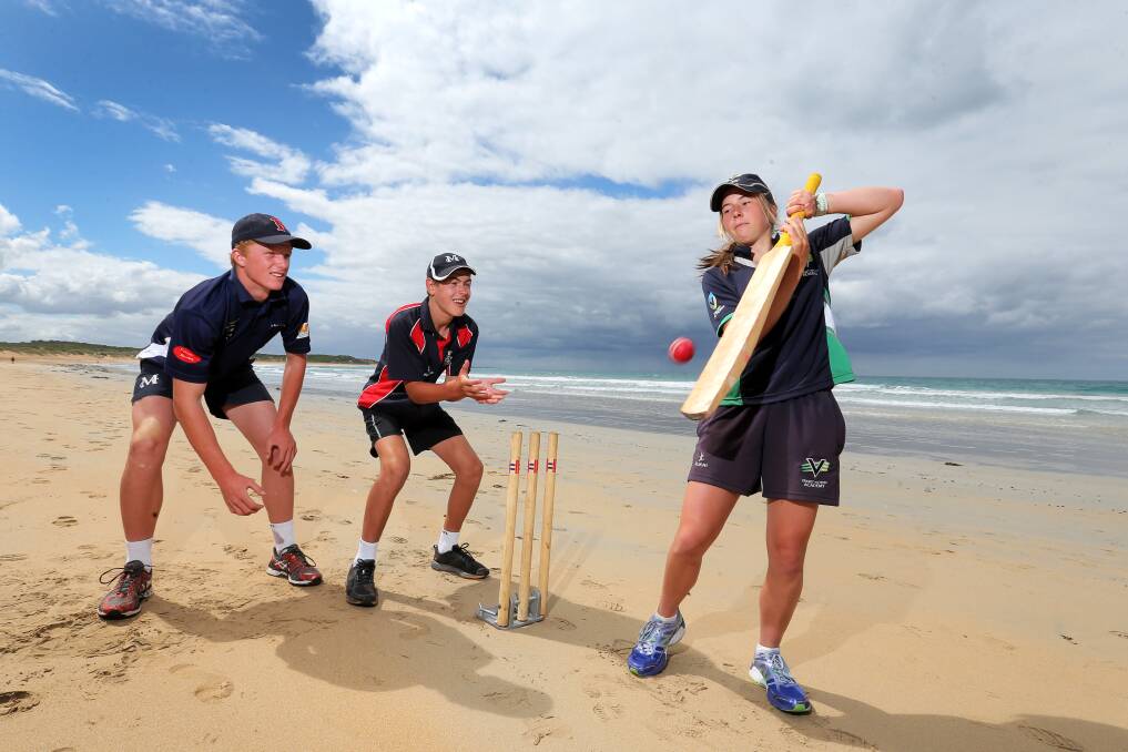 Georgia Wareham, 15, gives her cousins Lachlan Wareham, 16 (left), and Isaac Wareham, 13, some slips catching practice on the Warrnambool beach. A bat and ball are never far from the Mortlake trio, even on holidays. 150127RG04 Picture: ROB GUNSTONE