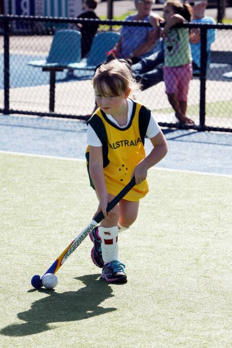 Stephanie Grist, 6, gets a feel for hockey, including an Australian uniform.