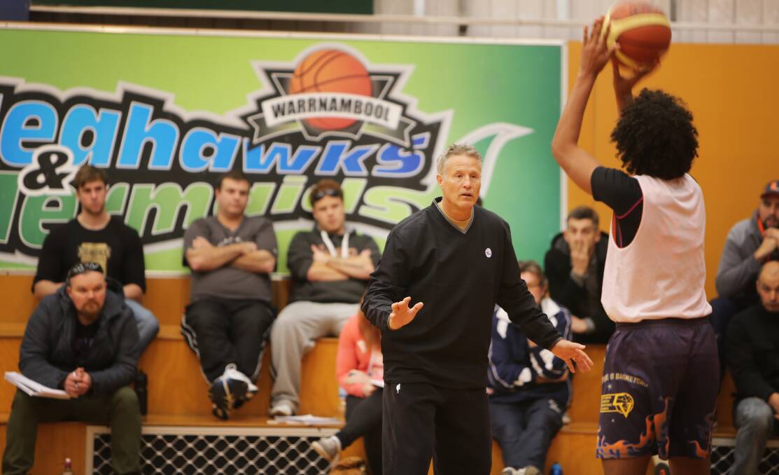 Philadelphia 76ers head coach Brett Brown demonstrates a defensive technique as he hits the court during a coaching seminar in Warrnambool.     140810AM18 
Picture: ANGELA MILNE