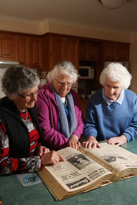 Barbara Mills (left), Evelyn McNally and Muriel McElgunn study newspaper reports of their sister Connie’s death 50 years ago.141203LP36 Picture: LEANNE PICKETT