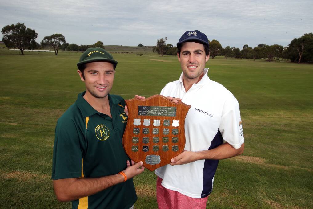 Bookaar captain Fraser Lucas (left) and Mortlake skipper Todd Lamont get to hold South West Cricket’s ultimate team prize before the grand final at Terang oval. Only one will be in possession after play today and tomorrow.150316DW26 Picture: DAMIAN WHITE