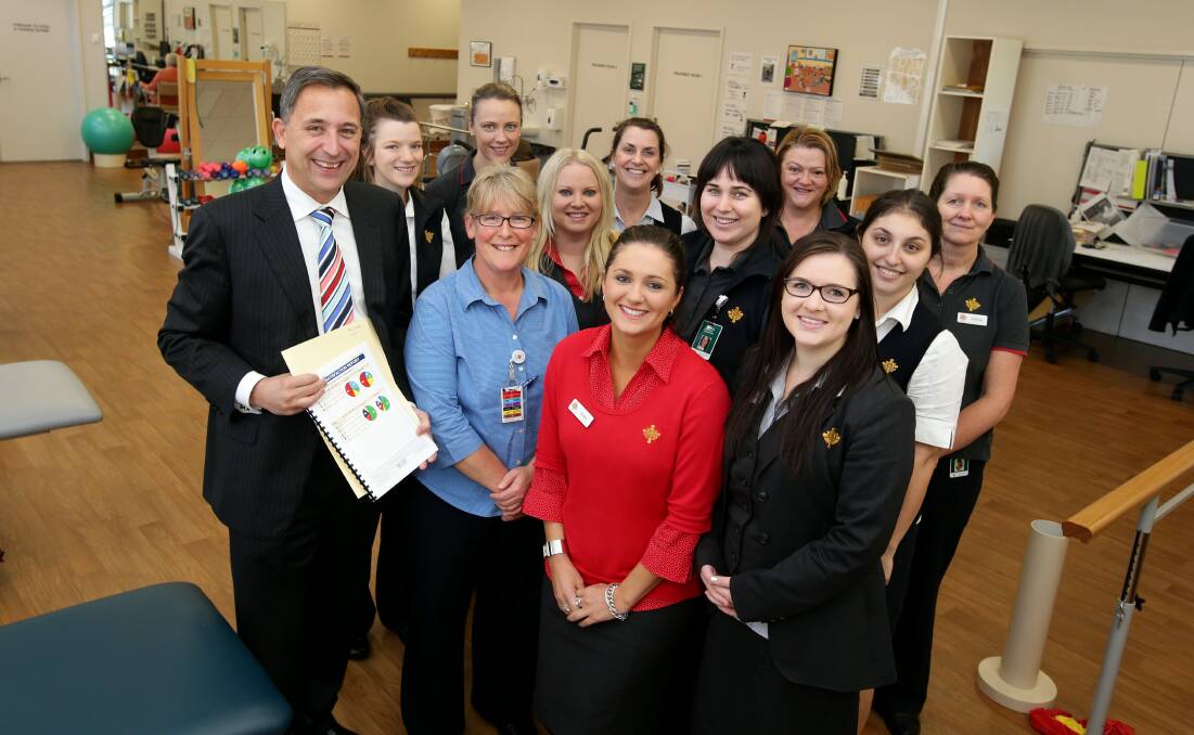 St John Of God Warrnambool Hospital chief executive officer Dr Glen Power (left) and director of nursing Leanne McPherson (blue shirt) celebrate the news they topped the Press Ganey survey with hospital staff. 