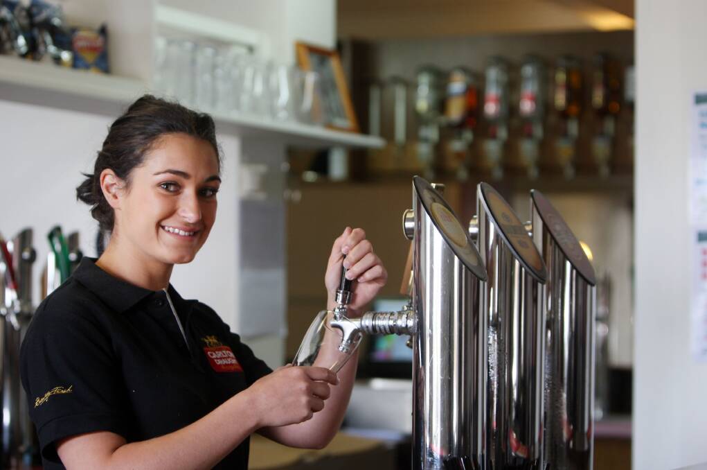 Royal Oak Hotel bar attendant  Bridget Anders prepares for today’s full reopening of the historic Port Fairy pub. 141224LP37 Picture: LEANNE PICKETT
