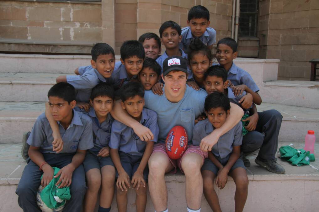 Essendon footballer Zach Merrett makes some new friends in India during an off-season initiative by the Bombers. Picture: ESSENDON FOOTBALL CLUB,